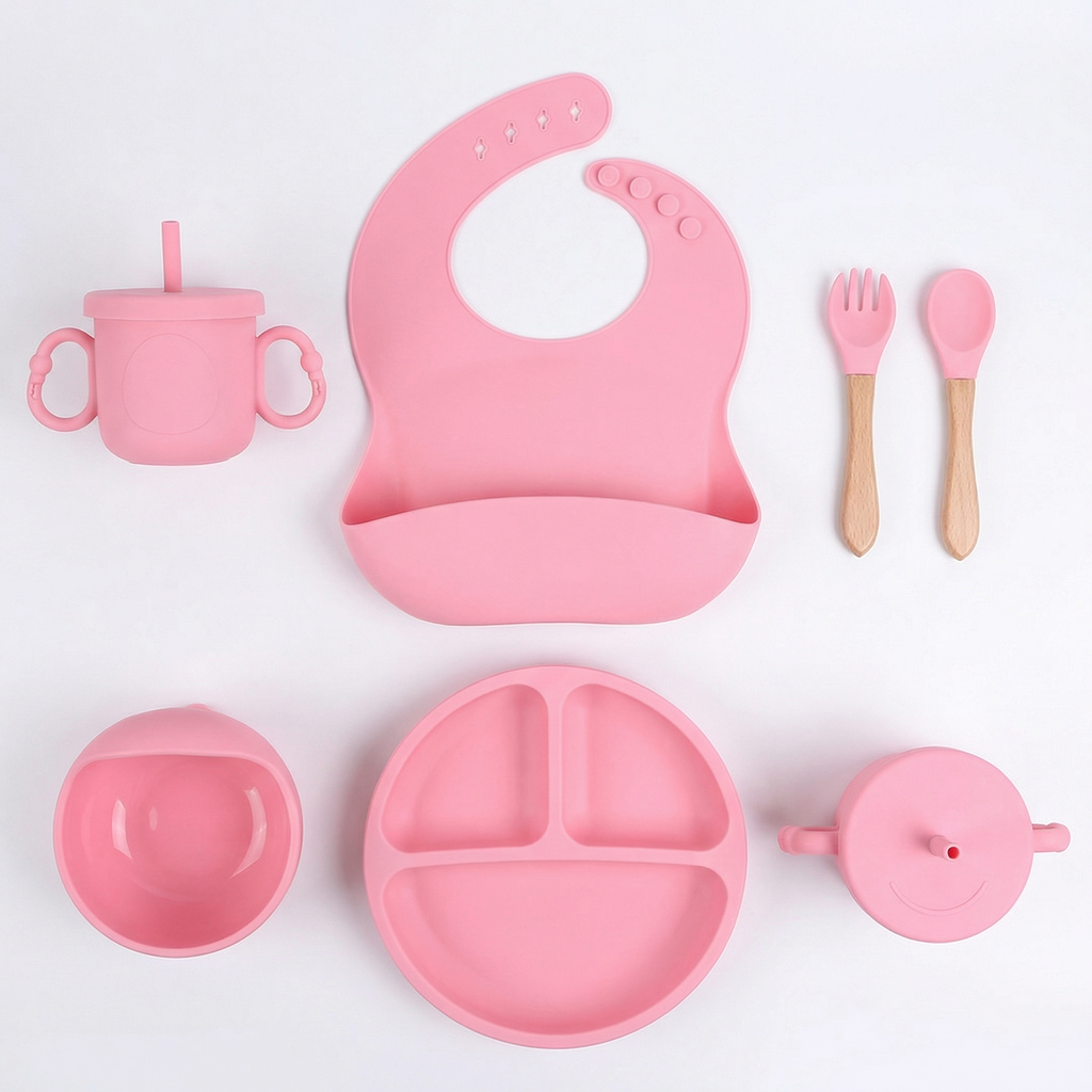 Pink silicone baby feeding set with bib, suction plate, bowl, straw cup, lid and wooden spoon and fork